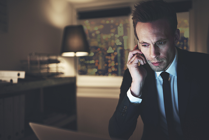 The finance adviser with phone browsing laptop The finance adviser with phone browsing laptop